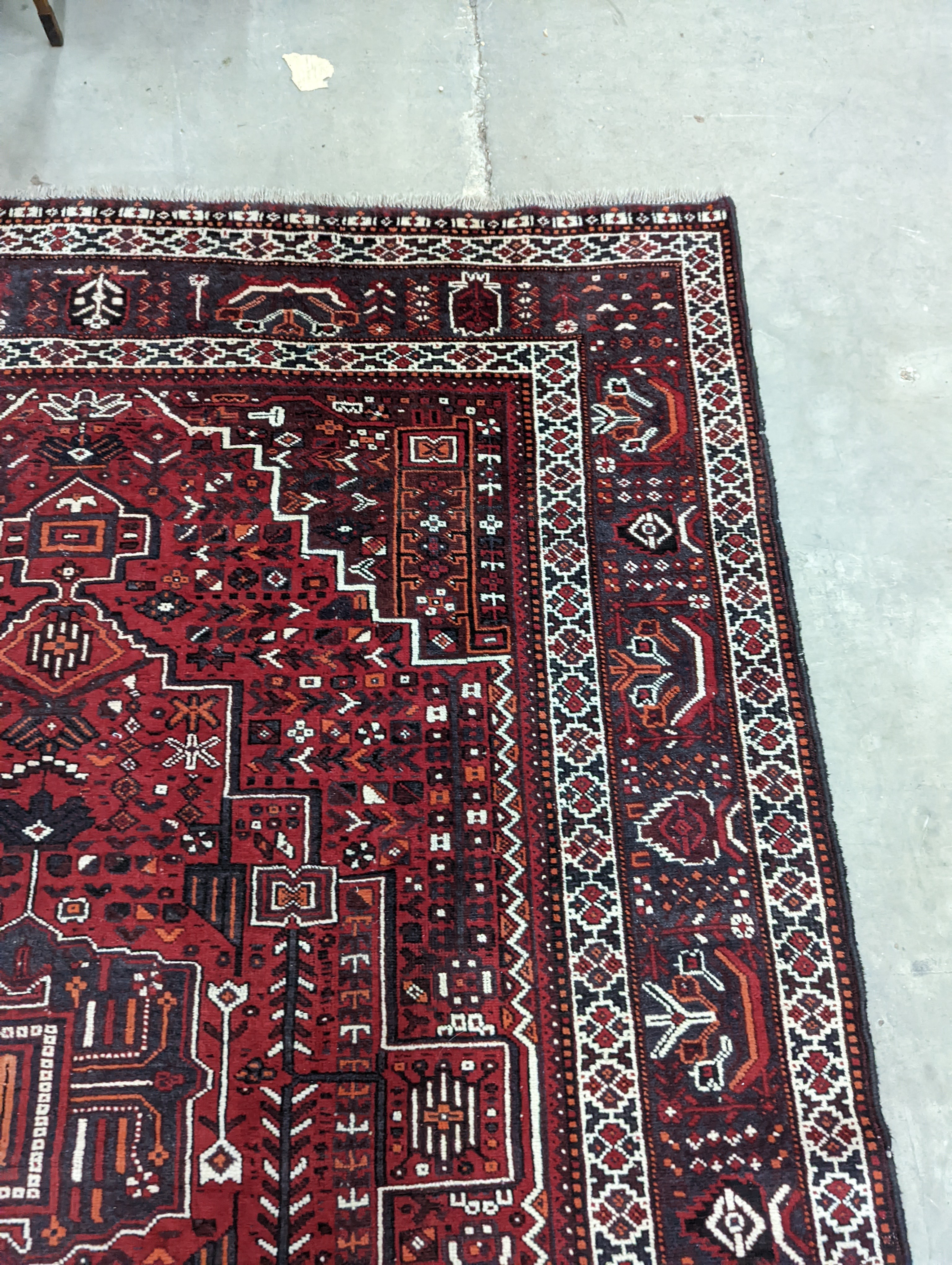 A Caucasian design burgundy ground carpet, 280 x 210cm